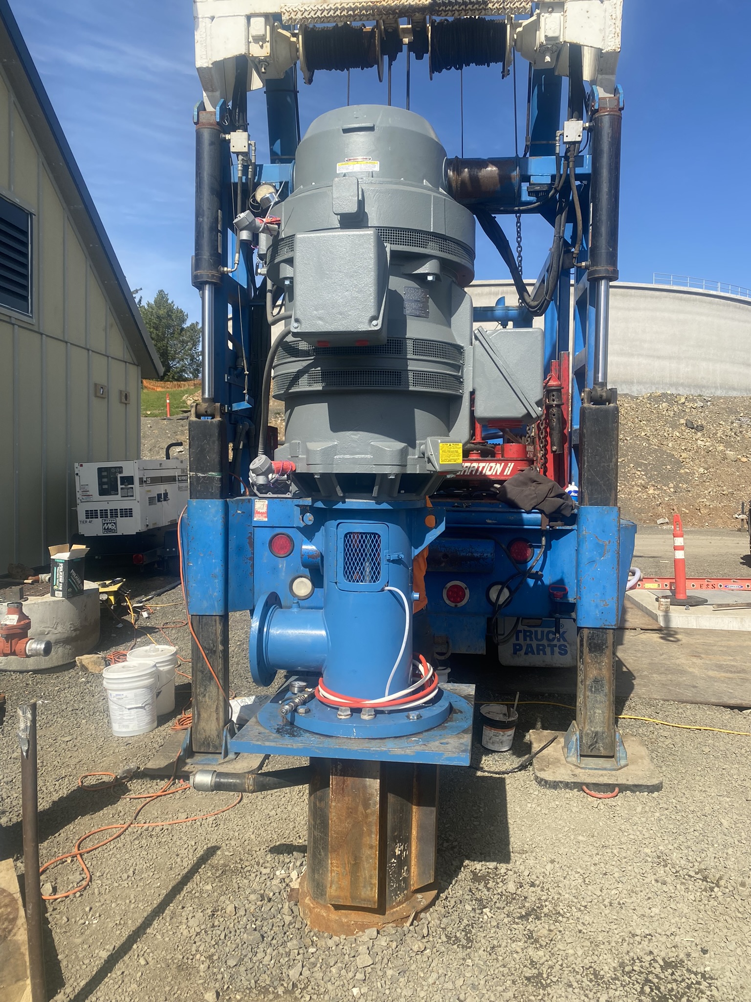 Schneider Water Services pumps and water system device on a gravel patch